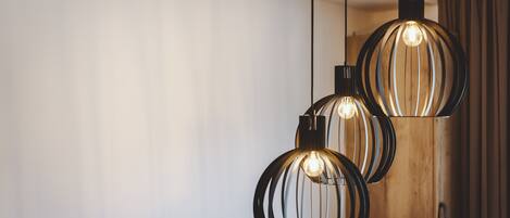 Three pendant lights with a spherical design and a visible filament bulb.