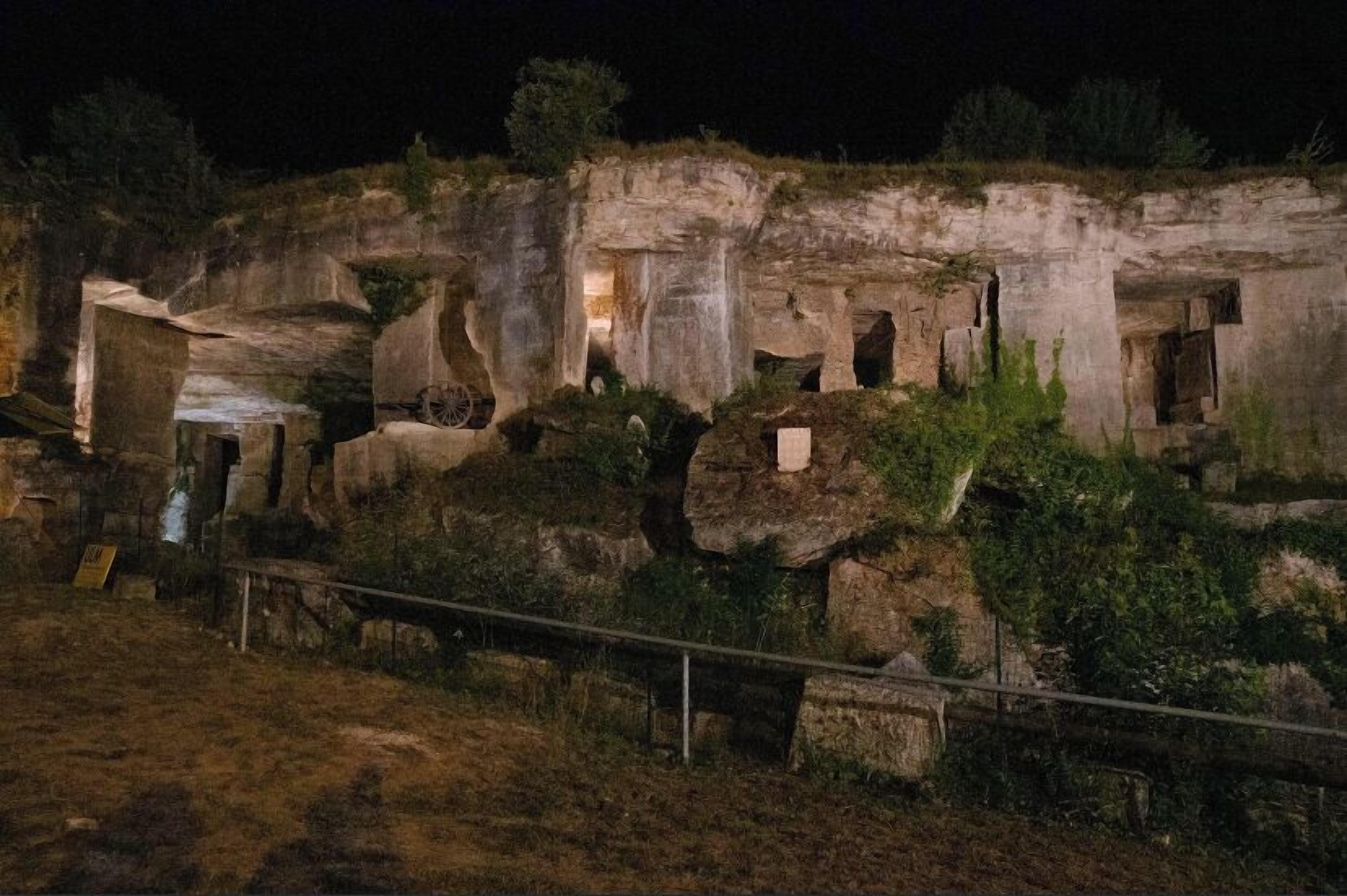 A historical site with ancient ruins, including stone structures and a pathway.