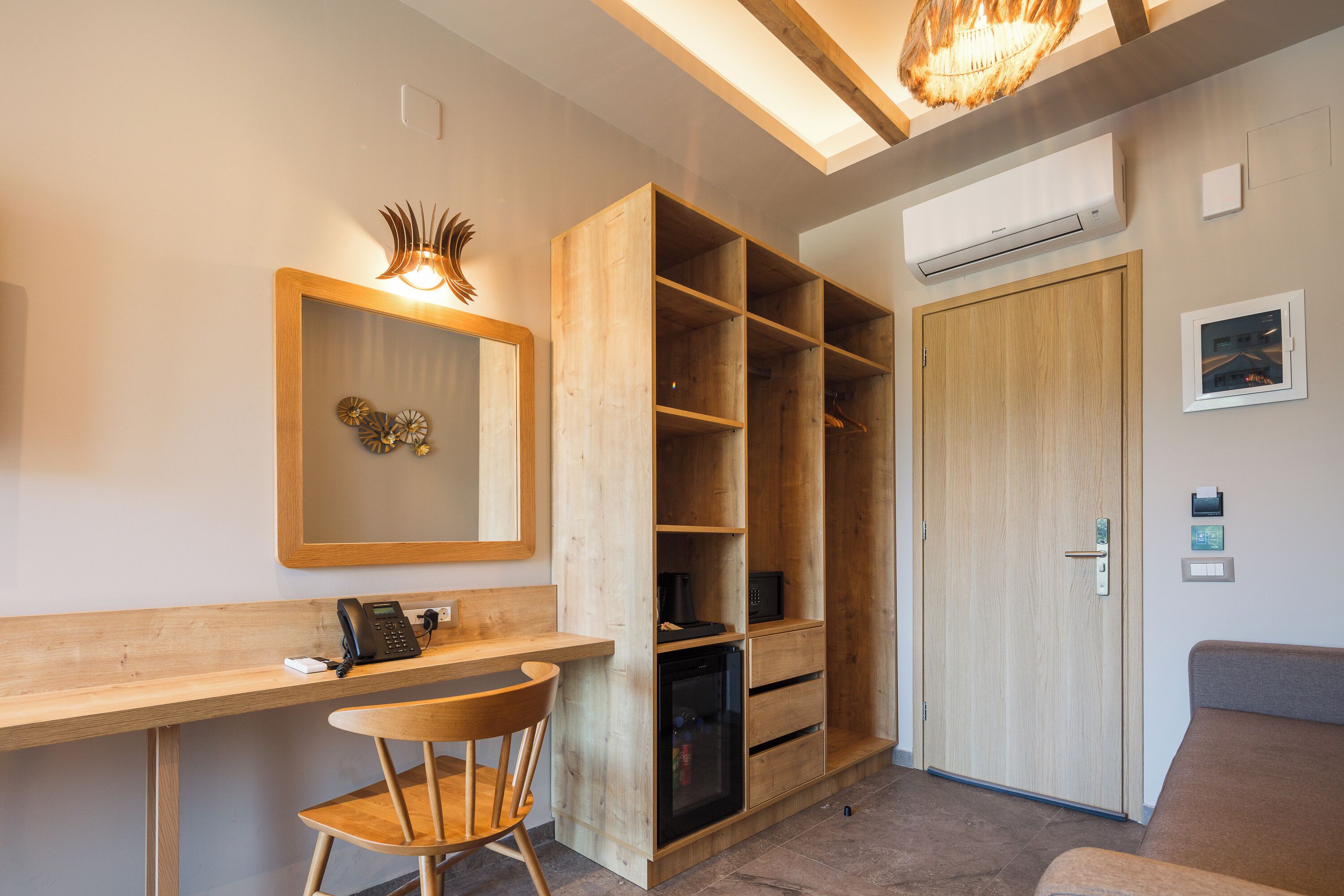 A modern room with a wooden desk, chair, and built-in shelving.