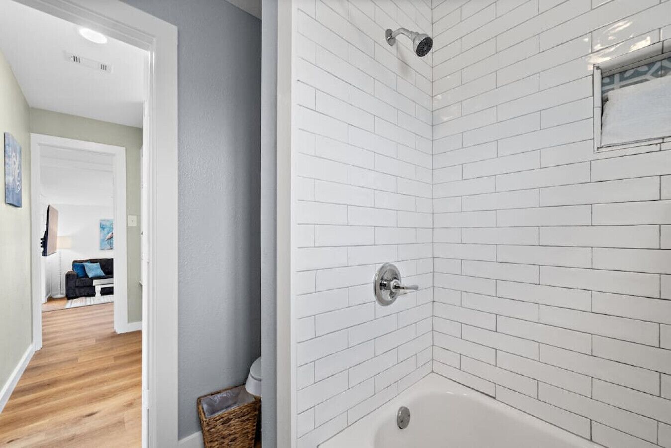 A modern bathroom with white subway tiles, a shower, and a bathtub.
