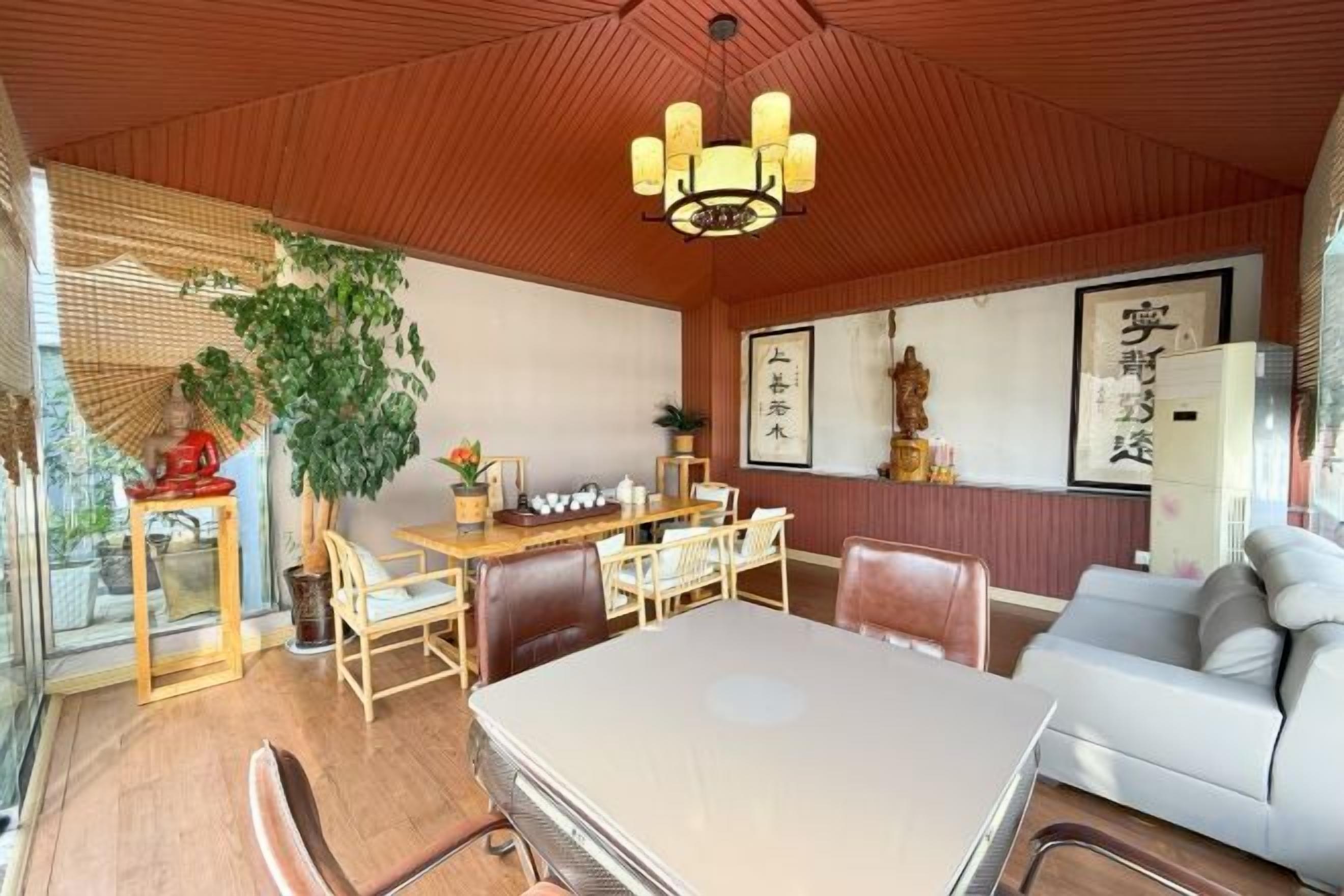 A traditional Japanese-style room with tatami flooring, a low table, and a sofa.