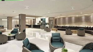 A spacious lobby with a modern design, featuring a seating area with sofas and chairs, a central column, and a decorative wall. - SM Mall of Asia MOA NAIA Pasay Staycation SMX Convention PICC World Trade Center (Pasay)