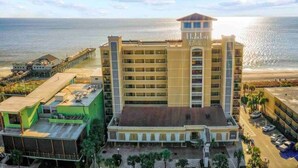 A multi-story hotel with a beach view, featuring a prominent 'Holiday Inn Express' sign.