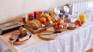 A breakfast buffet with various foods, condiments, and a toaster. - Mas Ribas Turismo Rural (Ventallo)