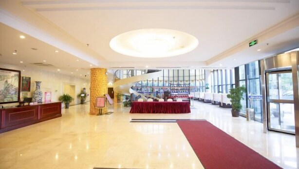 A spacious lobby with a marble floor, a reception desk, a staircase, and large windows. - Qingyuan Hotel University of Anhui (Hefei)
