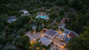 An aerial view of a resort with a swimming pool, outdoor seating areas, and stone buildings. - Pigreco 6+2, Emma Villas (Ostuni)