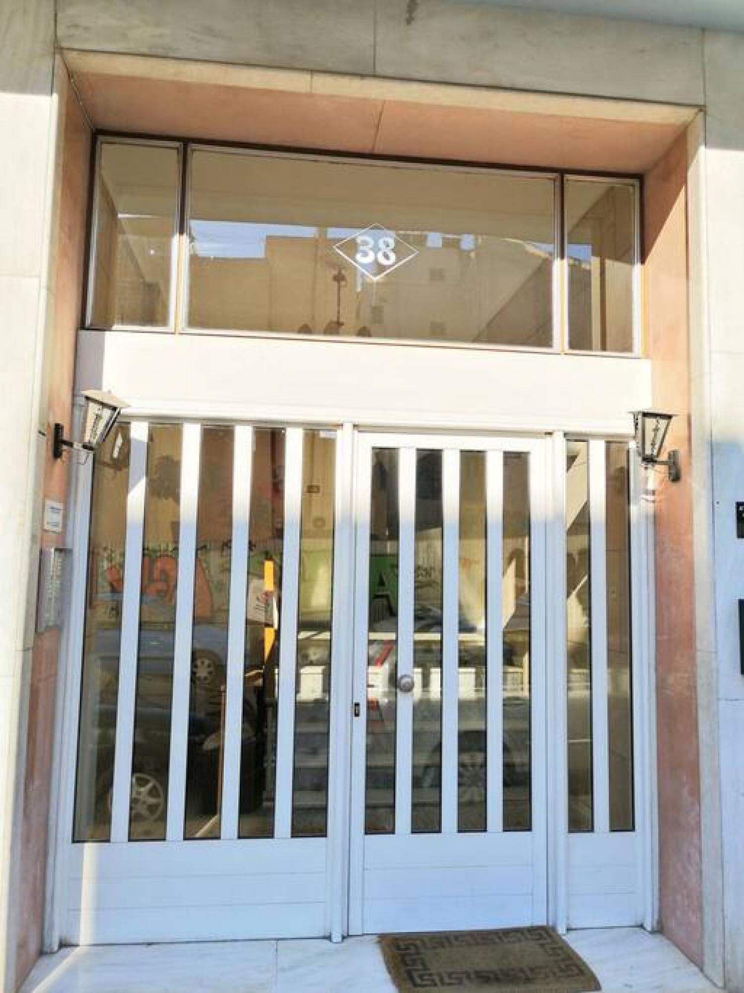 A double door entrance with a glass upper section and a white lower section.