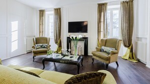 A living room with a fireplace, two armchairs, a sofa, and a coffee table. - Casa Antonia in Lucca (Lucca)