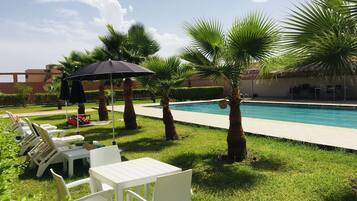 Piscine extérieure, parasols de plage, chaises longues