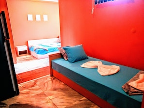 A small, compact room with a bed, a nightstand, and a tiled floor. - Sea Marble Villa Apartments (Sozopol)
