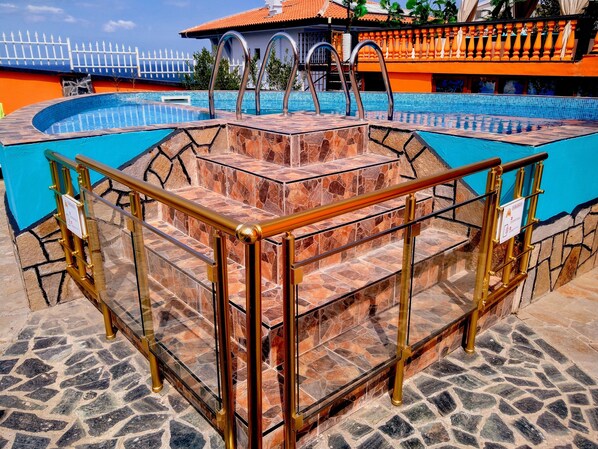 A pool area with a stone staircase and metal railings. - Sea Marble Villa Apartments (Sozopol)