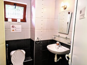 A bathroom with a toilet, a sink, a mirror, and a shower. There is a sign with a no smoking symbol and text. - Sea Marble Villa Apartments (Sozopol)