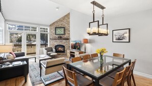 A modern living room with a fireplace, dining table, and comfortable seating. - Slopeside Paradise Penthouse At Lift 7, Views, Fireplace, Deck, Hot Tub 3 Bedroom Condo by RedAwning (Telluride)