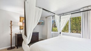 A bedroom with a four-poster bed, a nightstand, a lamp, a dresser, and a painting on the wall. - Riverside Dream! Quiet Spot W Deck, 5 Min Walk To Gondola & Main St. 2 Bedroom Condo by RedAwning (Telluride)