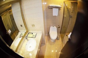 A bathroom with two sinks, a toilet, a shower, and a large mirror. - Wanjia Oriental Hotel (Nanjing County)