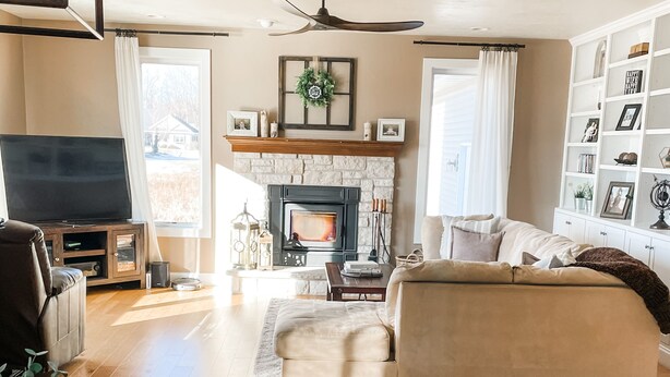 A spacious living room with a fireplace, a sofa, a coffee table, and a TV.