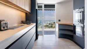 A modern kitchen with a view of the city. - The View CampsBay w/inifinity pool -5 mins from Beach (Cape Town)