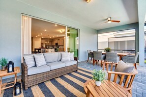 Relax in this inviting living area with a comfortable sofa, dining table, and potted plant.