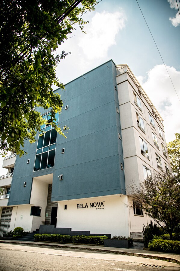 A modern building with a blue facade and the name "BELA NOVA" on the ground floor.