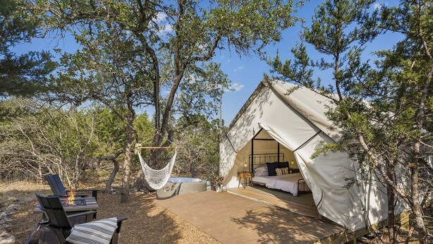 A tented accommodation with a bed, a hammock, and a fire pit. - Cherry Cove Glamping W/ Hot tub AND Cowboy Pool! (Fredericksburg)
