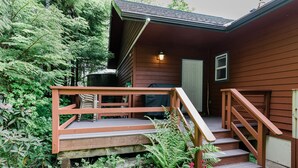 Ein Holzhaus mit Veranda, Treppe und Geländer.