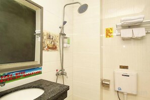 A bathroom with a sink, mirror, shower, and towel rack. - Xiangbali Express Hotel Guilin (Lingchuan)