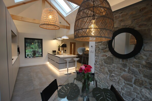 Enjoy meals in the dining area with a glass table and comfortable seating.