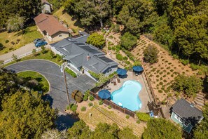 An aerial view of a residential property with a swimming pool, a covered patio, and a fenced yard. - Private Pool Villa for family getaways (Aptos)
