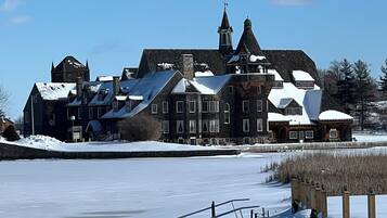 Een historisch gebouw met meerdere schoorstenen en een ruime binnenplaats.