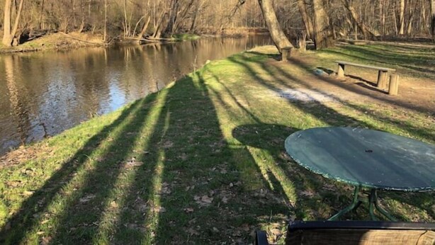 A riverside park with a picnic table and benches. - Horns Cabins - Allegheny Cabin by the roadside (Manns Choice)