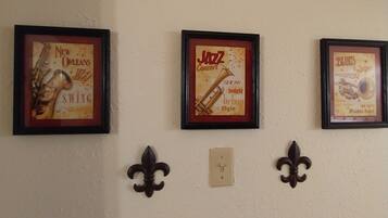 Three framed posters on a wall, each depicting different musical themes.