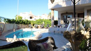 A pool area with lounge chairs and a decorative vase. - 2.5 Bed 2 Bath Home, Private Pool & Spacious, Sun, Beaches & Golf (Orihuela Costa)