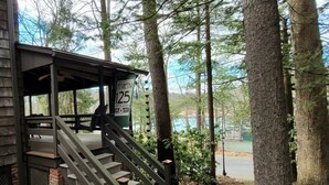A wooden staircase leading to a covered area with a sign indicating a price of $125. - Quiet Historic Cottage ▪︎ Spacious 4br Mount Gretna Retreat  (Mount Gretna)