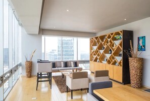 Deluxe Apartment | Living area | 50-inch LED TV with cable channels, TV, Netflix