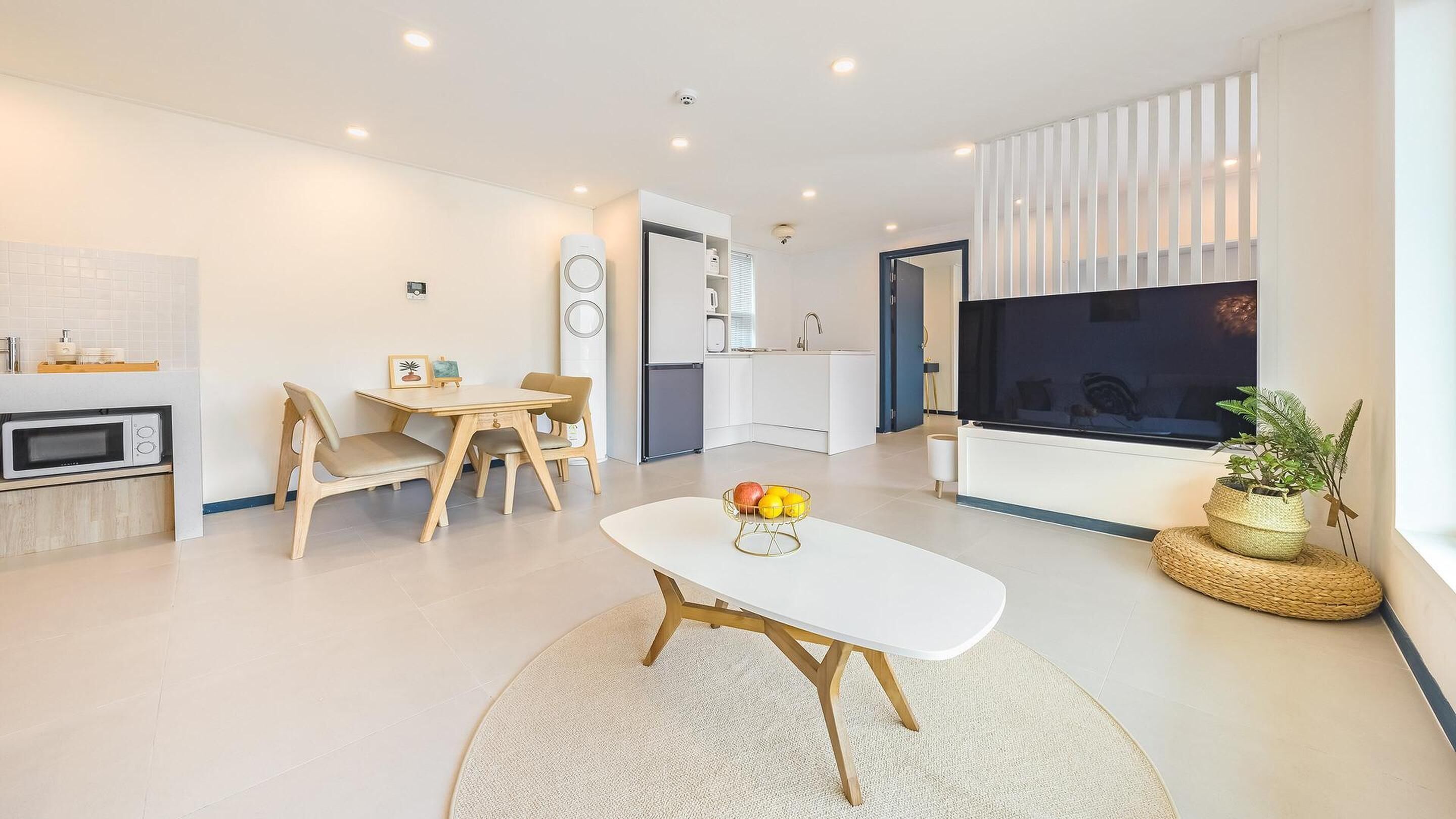A modern apartment with a kitchen, dining area, and living room.
