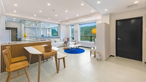 A modern kitchen with a dining area, large windows, and a black door. - Gapyeong Haneul Sanchaek Poolvilla Pensi (Gapyeong)
