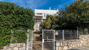 A gated entrance to a building with stone walls and a metal gate. - Bovolini's Room (Dubrovnik)