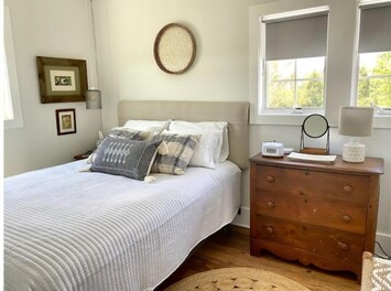 Queen bedroom.  Dresser provided for clothing with hangers.
