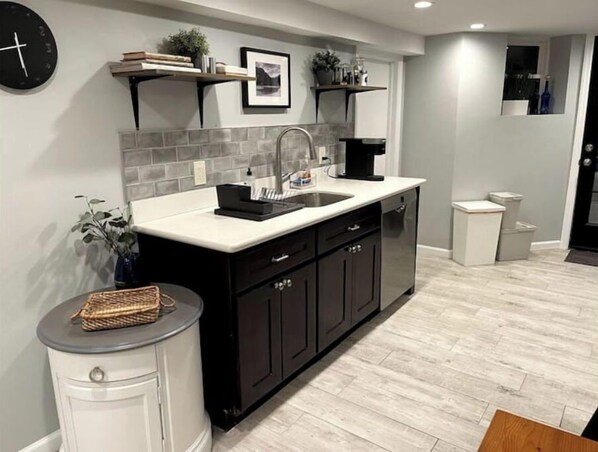 Enjoy cooking in this well-equipped kitchen with a central island, ample counter space, dishwasher, and coffee maker.