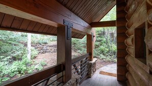 A wooden cabin with a stone foundation, large windows, and a wooden deck. - New! Chic European Style Cabin, Short Walk To Ski 3 Bedroom Home by RedAwning (Telluride)
