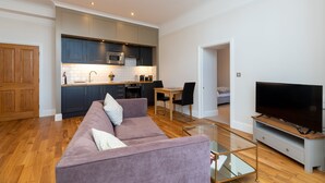 A modern apartment with a kitchen, dining area, and living room.