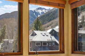 A room with large windows offering a mountain view. - Lodge Life! Walk Or Shuttle To Lifts + Fireplace, Hot Tub 2 Bedroom Condo by RedAwning (Telluride)