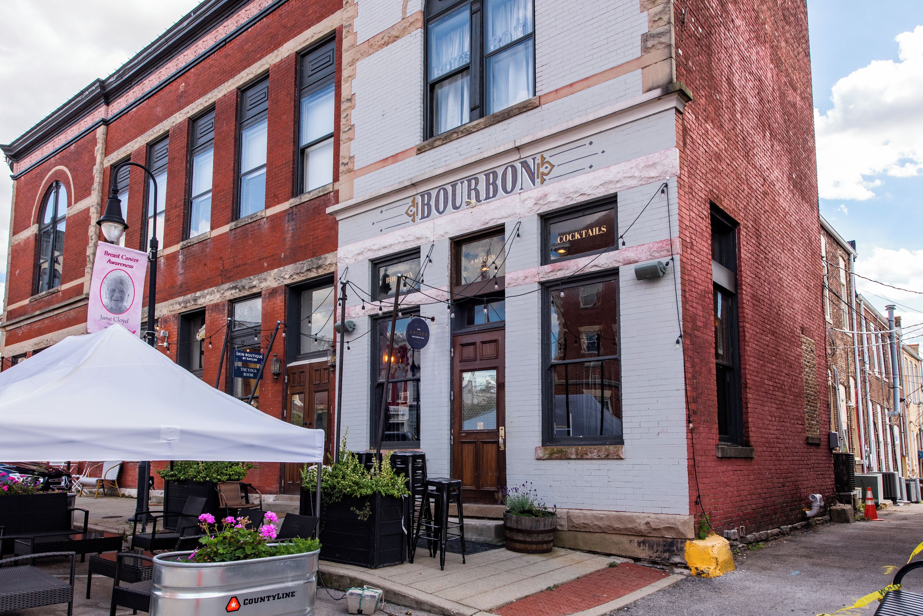 A brick building with a white facade and a sign reading "BOURBON".