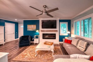 Relax in this inviting living room with a fireplace, flat-screen TV, and comfortable sofa.