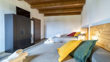 A bedroom with a bed, a wardrobe, and a flat-screen TV.