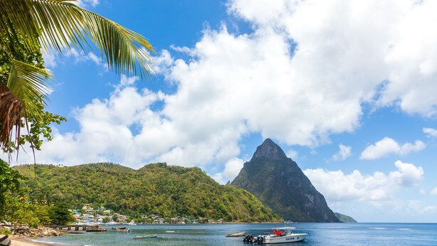 A beach with boats, a mountain, and a clear sky. - TOPAZ APARTMENT VILLA -  MOUNTAIN VIEW VILLA (SOUFRIERE)