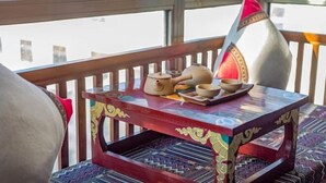 A wooden table with a patterned tabletop and a decorative item on it. - Ruifeng Impressed Hotel (Shangri-La)