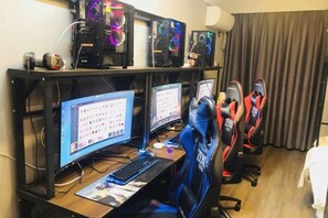 En speluppsättning med flera skärmar, ett tangentbord och en spelstol.