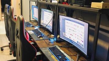 A row of computer workstations with multiple monitors, keyboards, and mice.