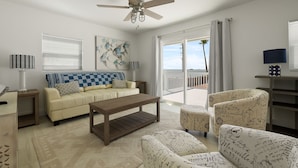 A modern living room with a beige sofa, a wooden coffee table, patterned armchairs, a ceiling fan, and a view of the outdoors through a sliding glass door. - Dog-Friendly Cottage with Ocean Views! Private Heated Pool & Hot Tub! (South Padre Island)